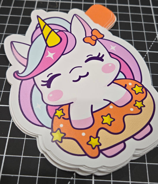Sticker of a unicorn with a rainbow-colored shell on a grid background
